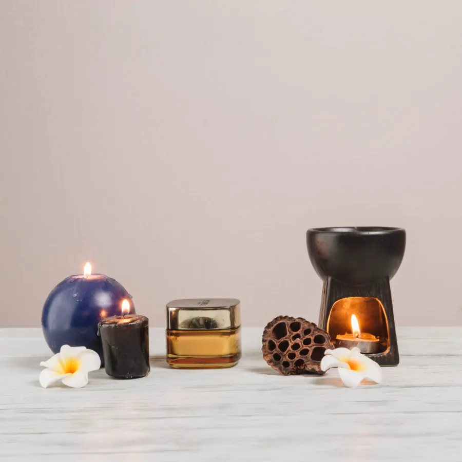 Lit candles and spa stones, softened behind the headline figure